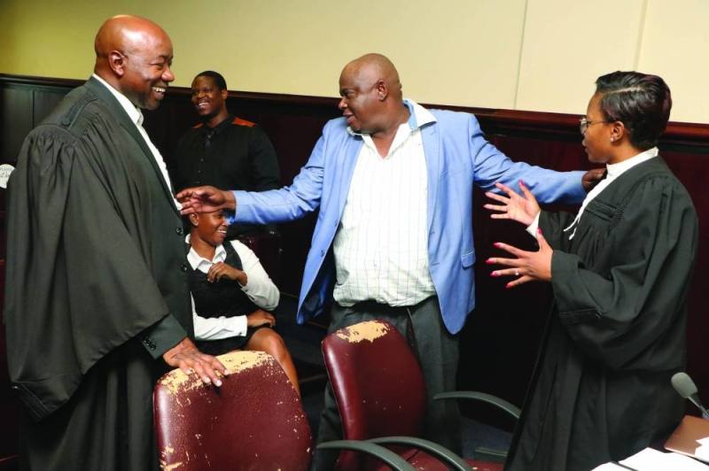 Chalegwa Mabua in consultation with his lawyers during their case with Mascom at Gaborone high court PIC: PHATSIMO KAPENG.